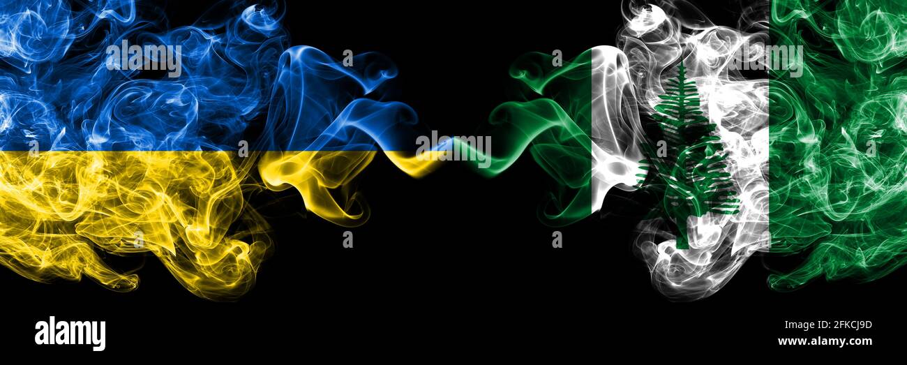 Ukraine, Ukrainian vs Australia, Australian, Norfolk Island smoky mystic flags placed side by side. Thick colored silky abstract smokes flags. Stock Photo