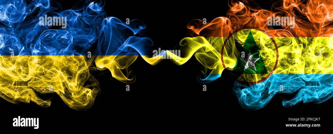 Ukraine, Ukrainian vs Cabinda smoky mystic flags placed side by side. Thick colored silky abstract smokes flags. Stock Photo