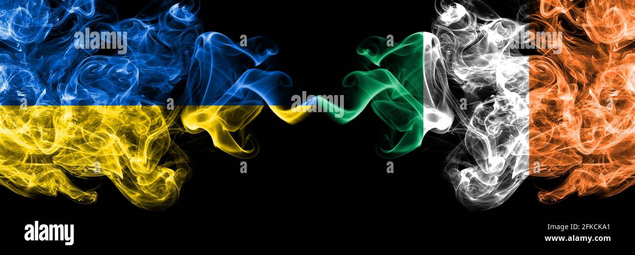 Ukraine, Ukrainian vs Ireland, Irish smoky mystic flags placed side by side. Thick colored silky abstract smokes flags. Stock Photo