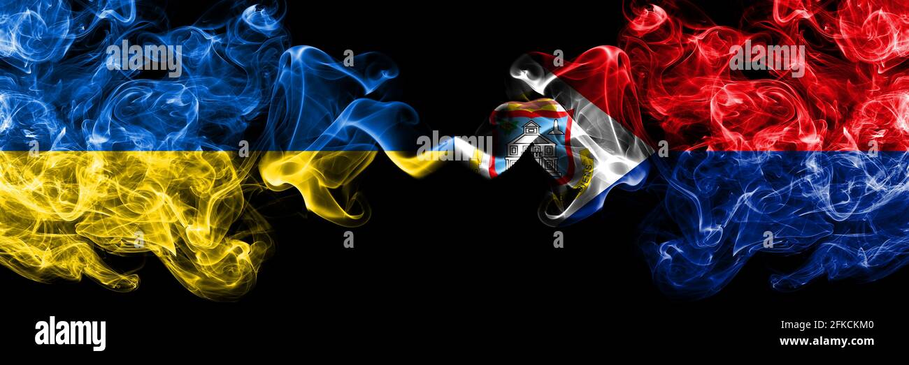 Ukraine, Ukrainian vs Netherlands, Dutch, Holland, Sint Maarten smoky mystic flags placed side by side. Thick colored silky abstract smokes flags. Stock Photo