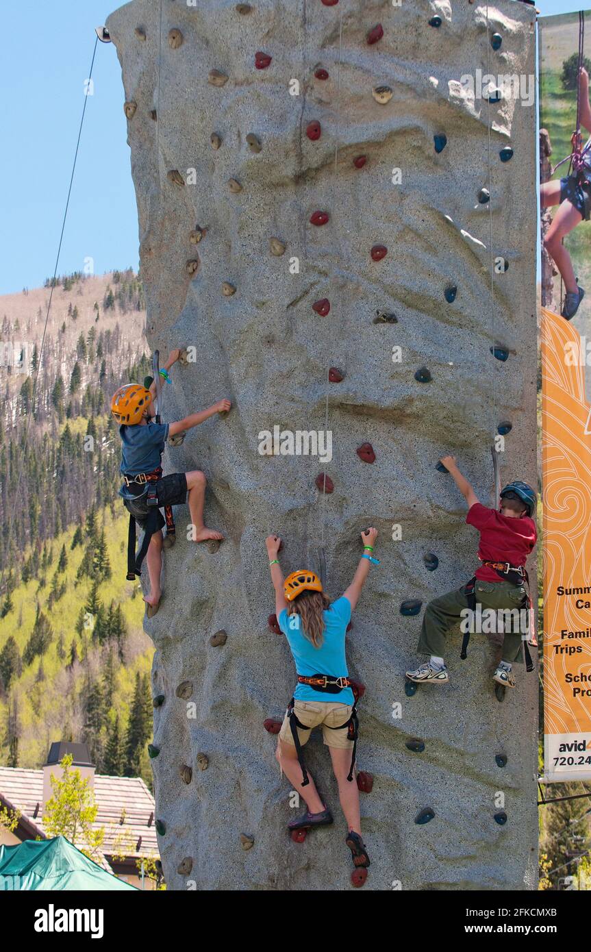 Children climbing safely an artificial wall in Vail, Colorado, USA Stock Photo