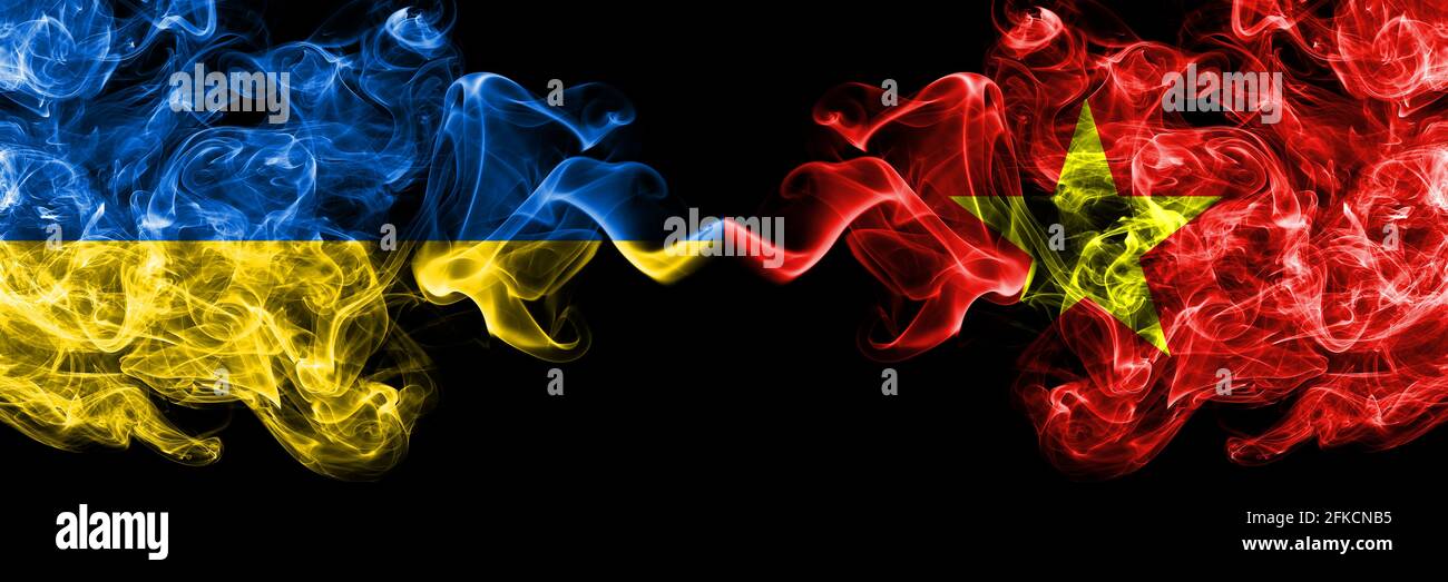 Ukraine, Ukrainian vs Vietnam smoky mystic flags placed side by side. Thick colored silky abstract smokes flags. Stock Photo