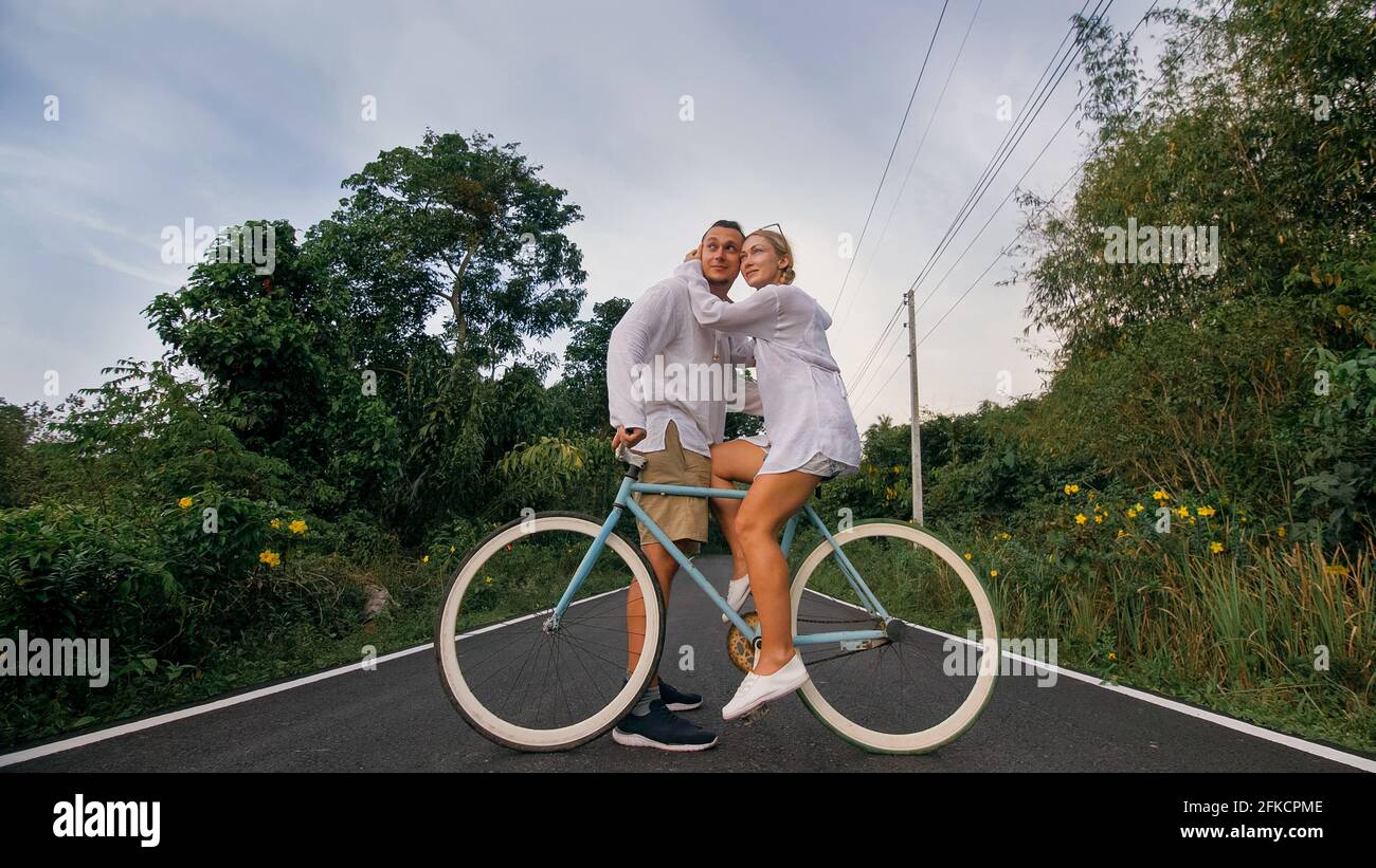 Biking road trip. Love couple on blue 
