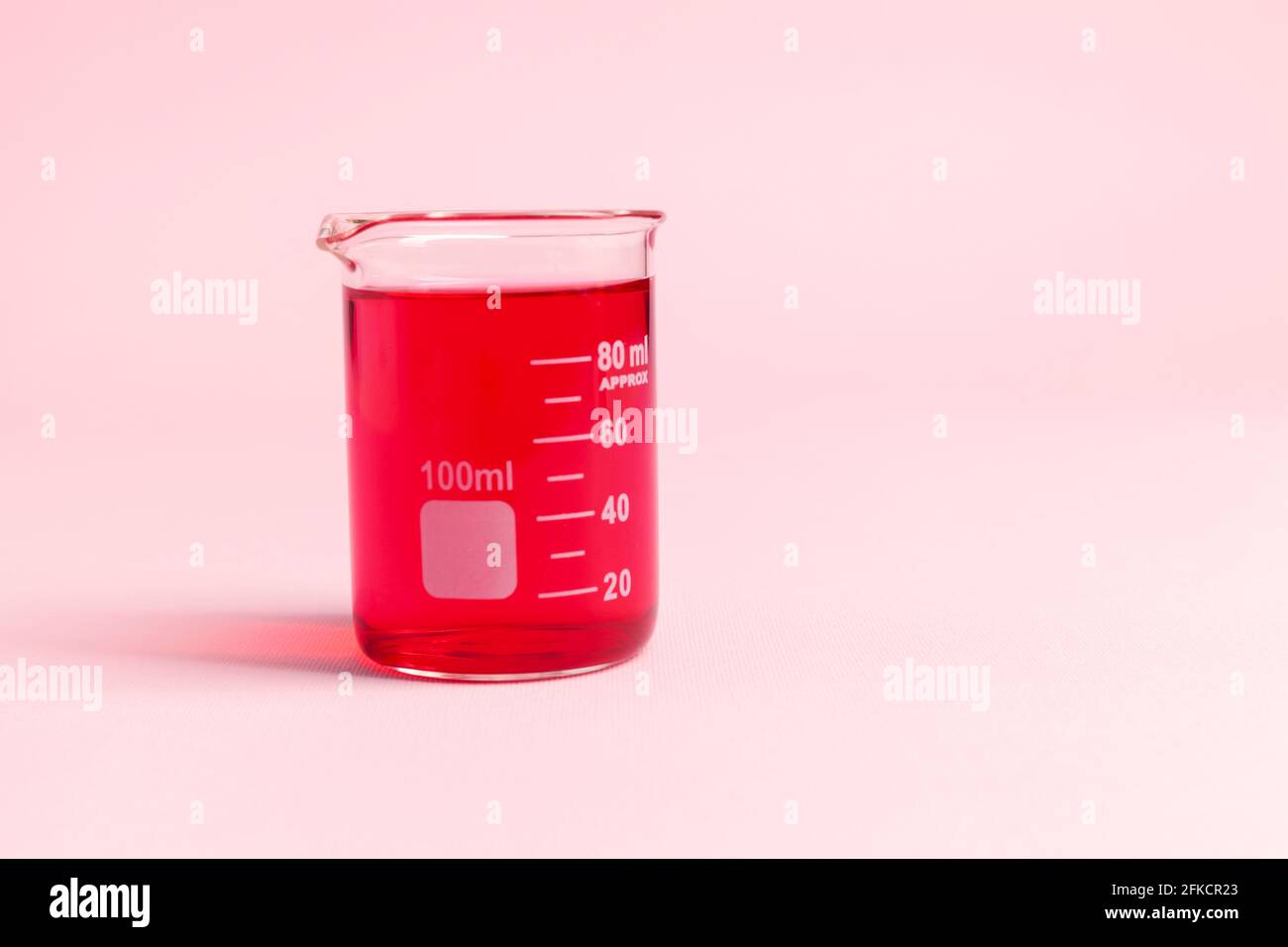 a glass vessel for a chemical laboratory with a red liquid, close up