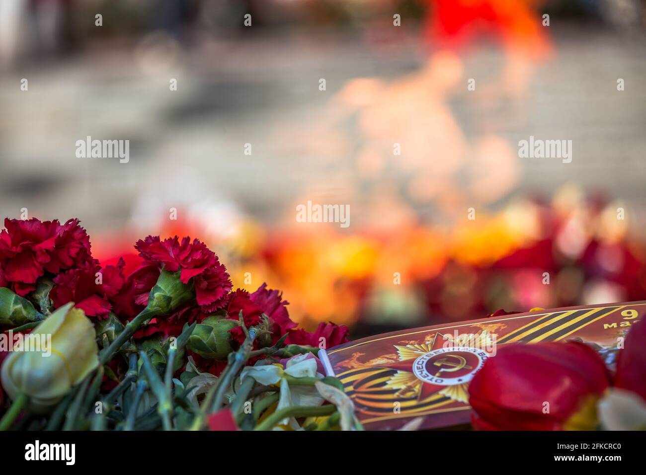 flowers at the memorial fire. the memory of the fallen soldiers in the ...