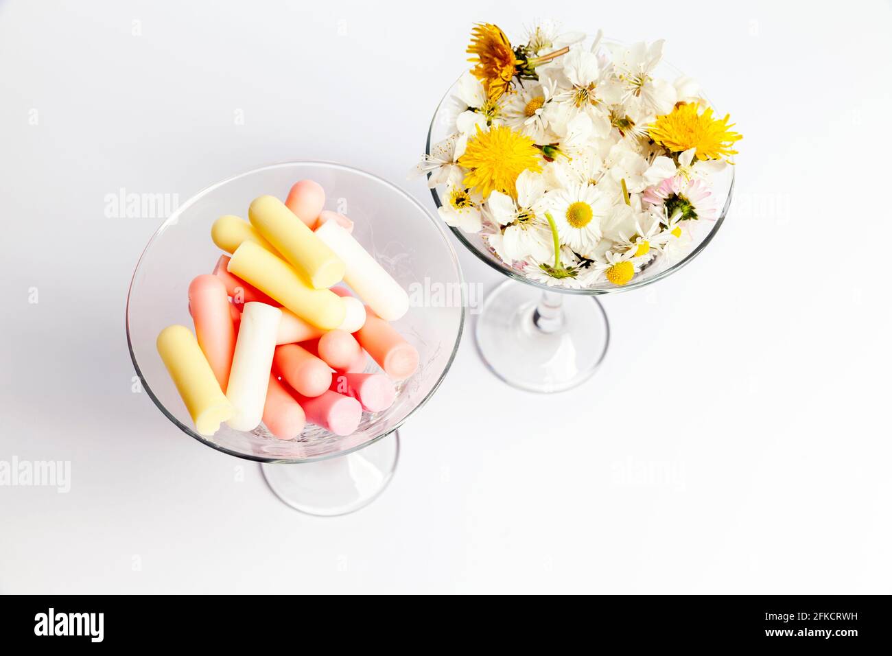 cosmetic background with cosmetic sticks and flovers in the glass, close up Stock Photo