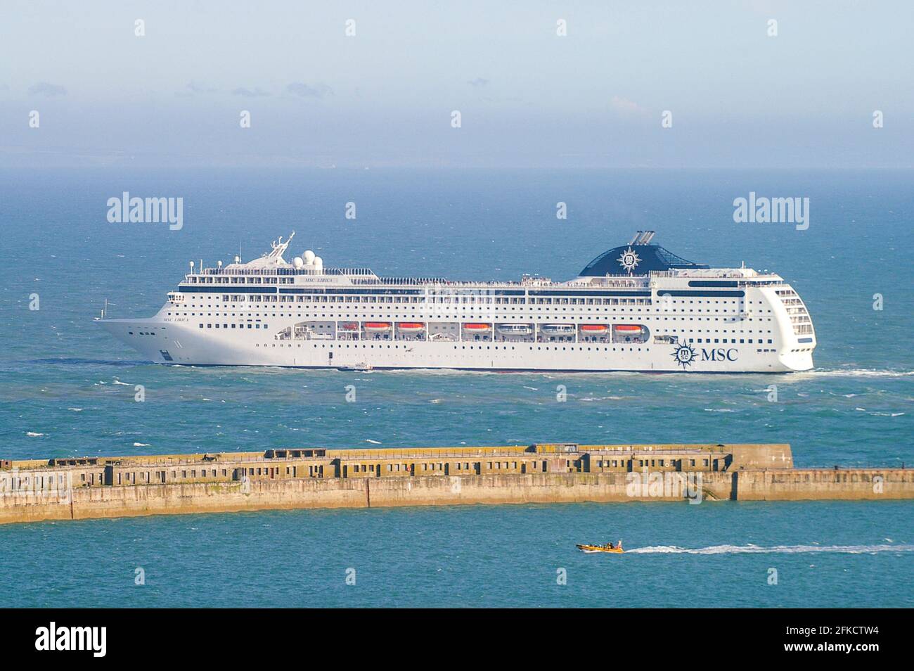 MSC Lirica, cruise ship, luxury liner leaving the Port of Dover, the cross-channel port situated in Dover, Kent, SE England. Cruise liner departing Stock Photo