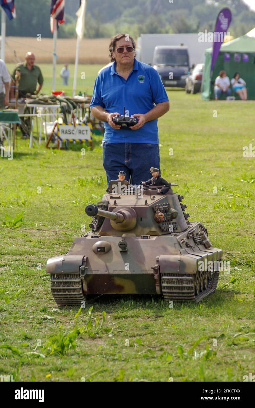 Person controlling a very large radio controlled German Panther Army tank, of the Second World War at an outside military event. Hobby. Big scale Stock Photo