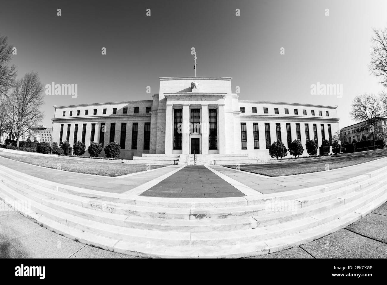 WASHINGTON, DC - Wide-angle photo of the national headquarters of the US Federal Reserve System housed in the Eccles Building on Constitution Avenue in Washington DC. It houses the main offices of the Board of Governors of the Federal Reserve. The Federal Reserve, or The Fed, as it is often known, is the central banking system of the United States. Established by the Federal Reserve Act in 1913, it has three key objectives for US monetary policy: maximizing employment, stabilizing prices, and moderating long-term interest rates. The building is named after Marriner S. Eccles (1890–1977), Chair Stock Photo