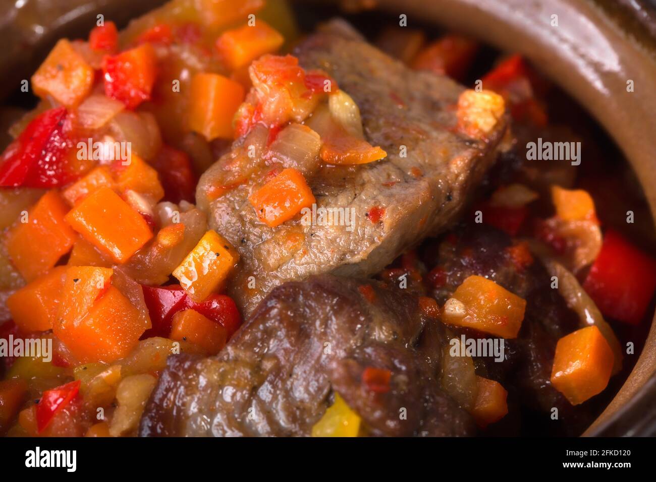 Pot roast pork meat with minced vegetables as a traditional balkan kitchen. Macro. Photo can be used as a whole background. Stock Photo