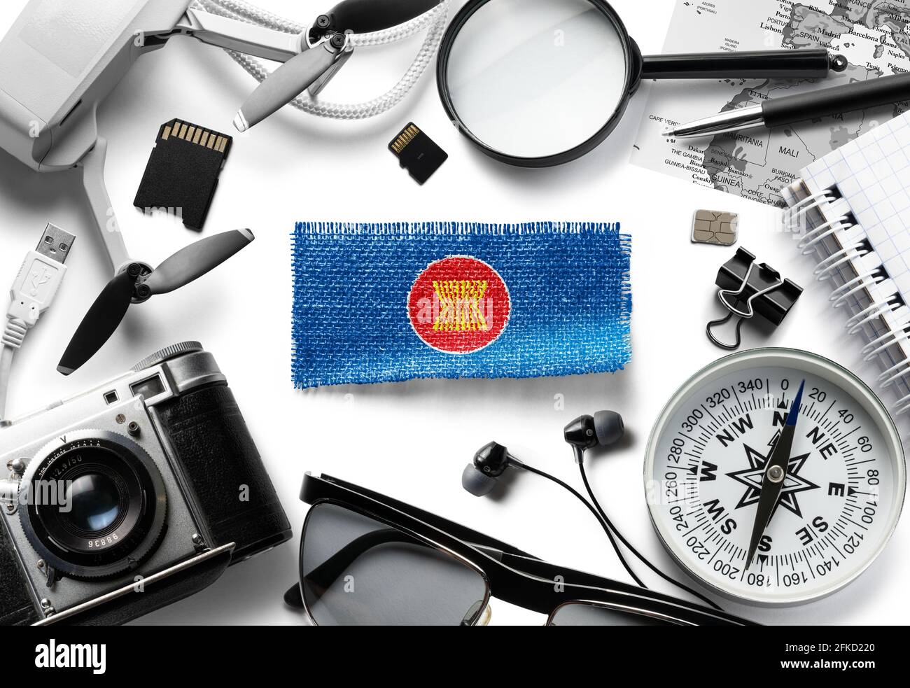 Flag of ASEAN and travel accessories on a white background. Stock Photo