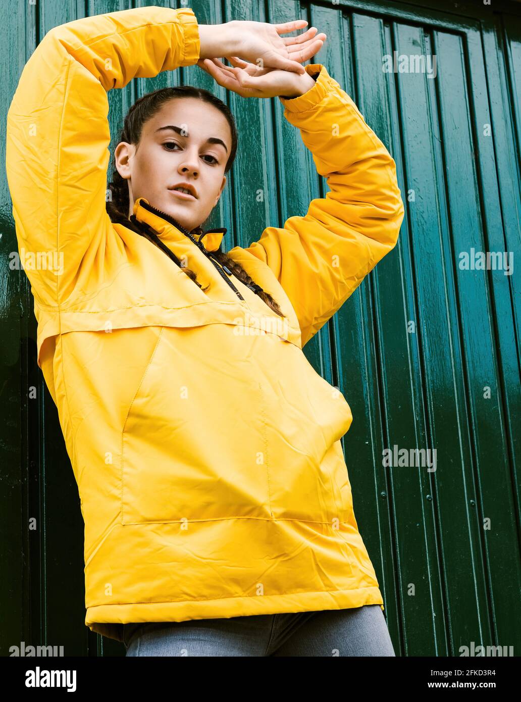 Portrait of teenage girl wearing yellow coat Stock Photo