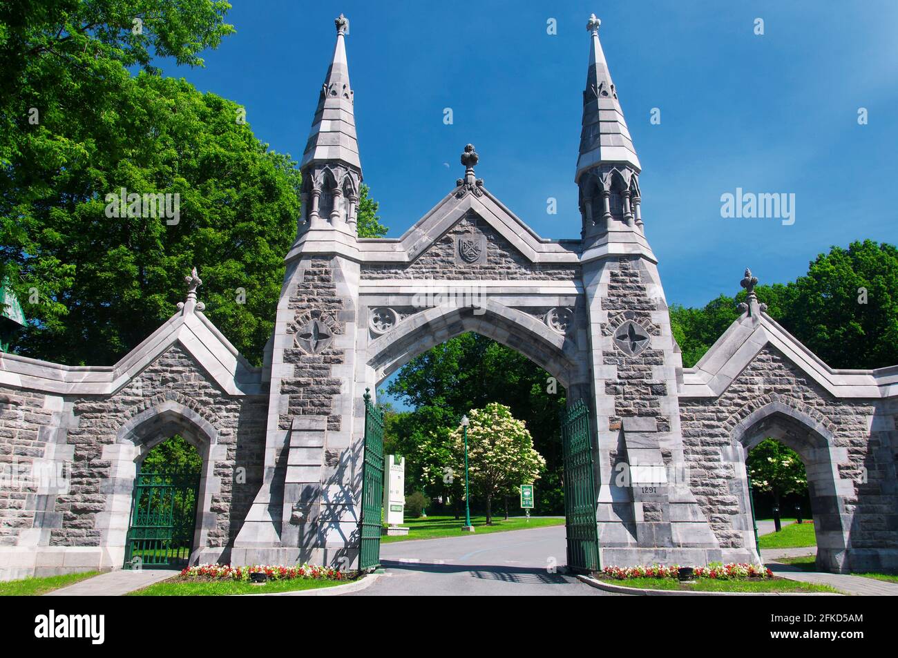 The main entrance and gate to the mount royal cemetery in montreal canada on a sunny blue sky day. Stock Photo