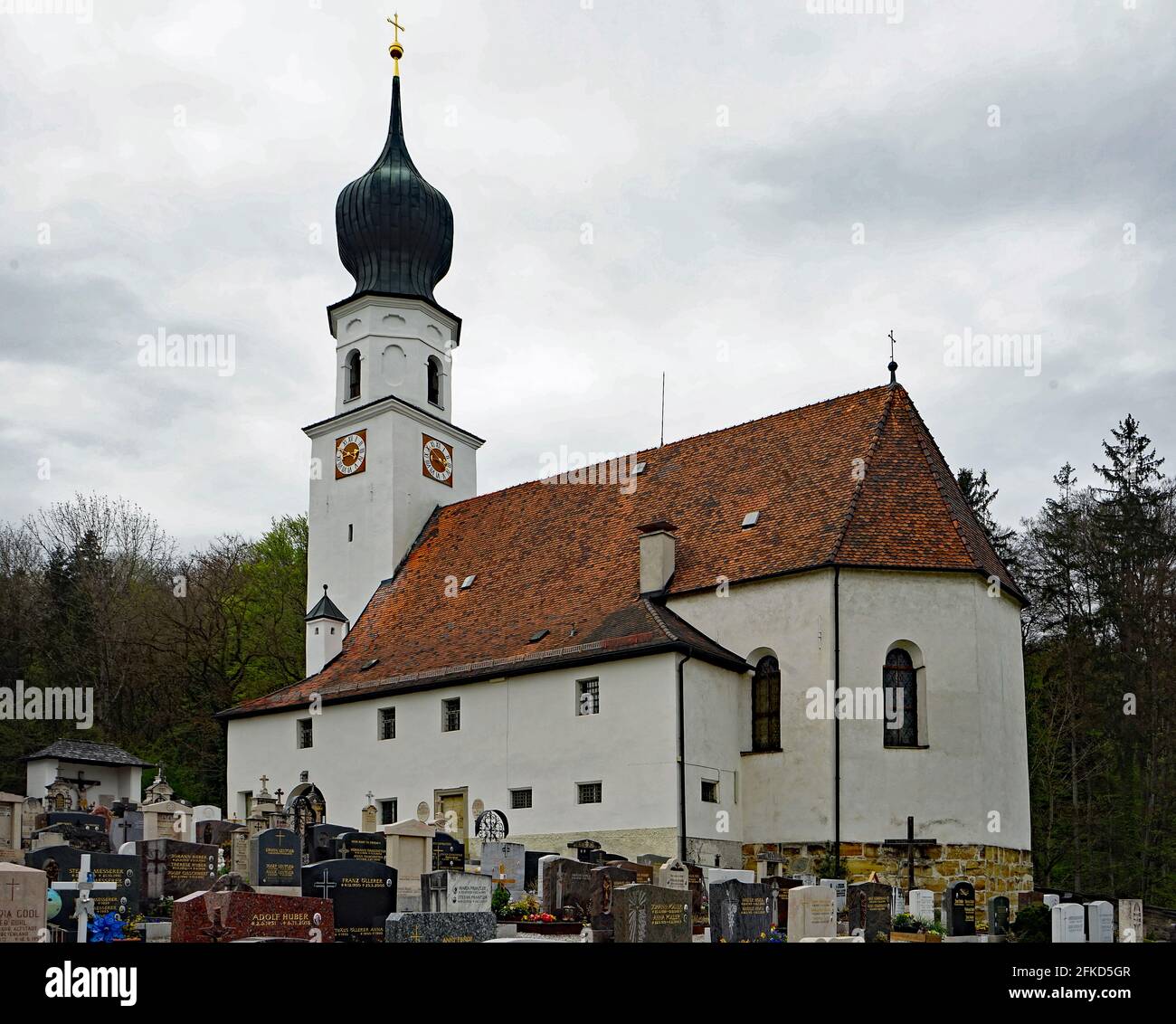 Ainring, St. Laurentius, church with cimetry  in Ainring Kirche mit Friedhof, Bavaria, Germany, April 2021 Stock Photo