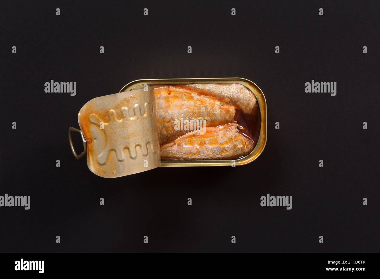can of pickled sardines on black background Stock Photo