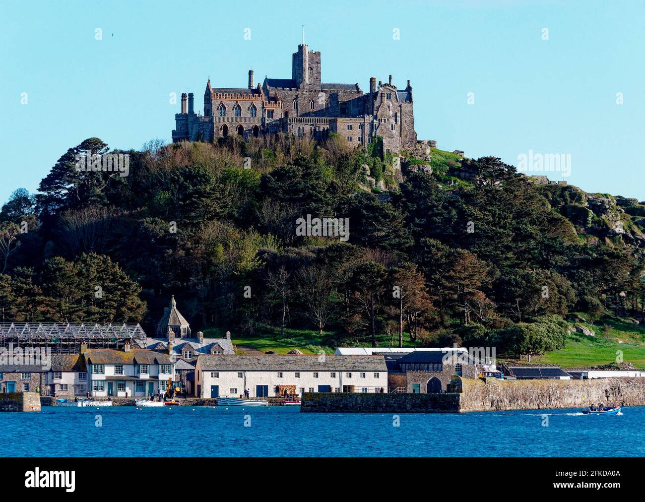 St Michaels Mount, Cornwall. The National Trust ground has been given over as a huge film set to the HBO  production, House of the Dragon. The latest development in the Game of thrones franchise. This prequel is set 300 years prior to the beginning of Game of Thrones . Film crew are caught out on the tidal causeway, Smoke machines on the water and Knights of the Iron Throne enjoy refreshments at the cafe facility.  30th April 2021. Credit: Robert Taylor/Alamy Live News” Stock Photo