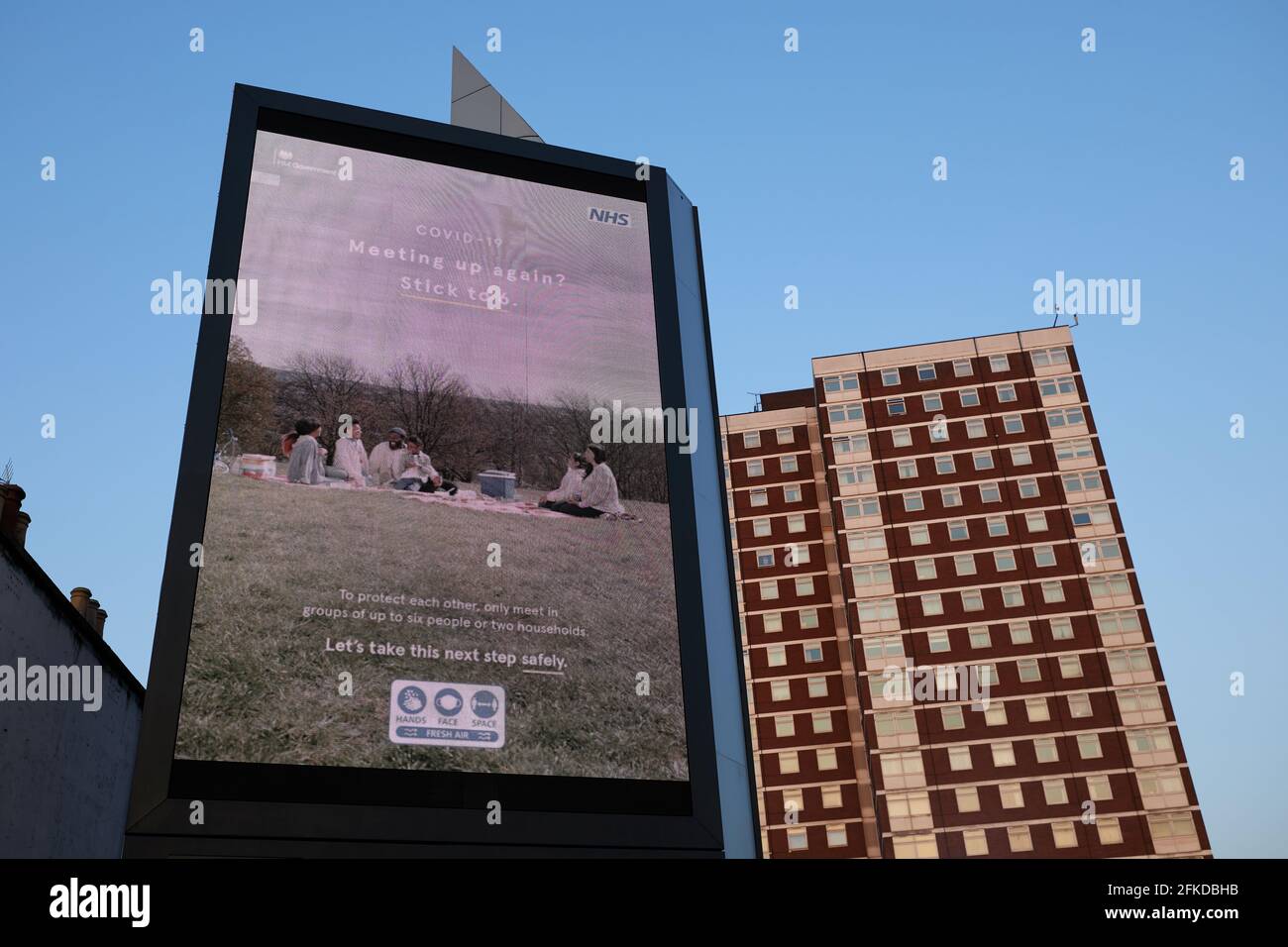 London, UK - 20 Apr 2021: A government advert reminds people to adopt the rule of 6 when meeting outside as coronavirus restrictions start to be lifted. Stock Photo