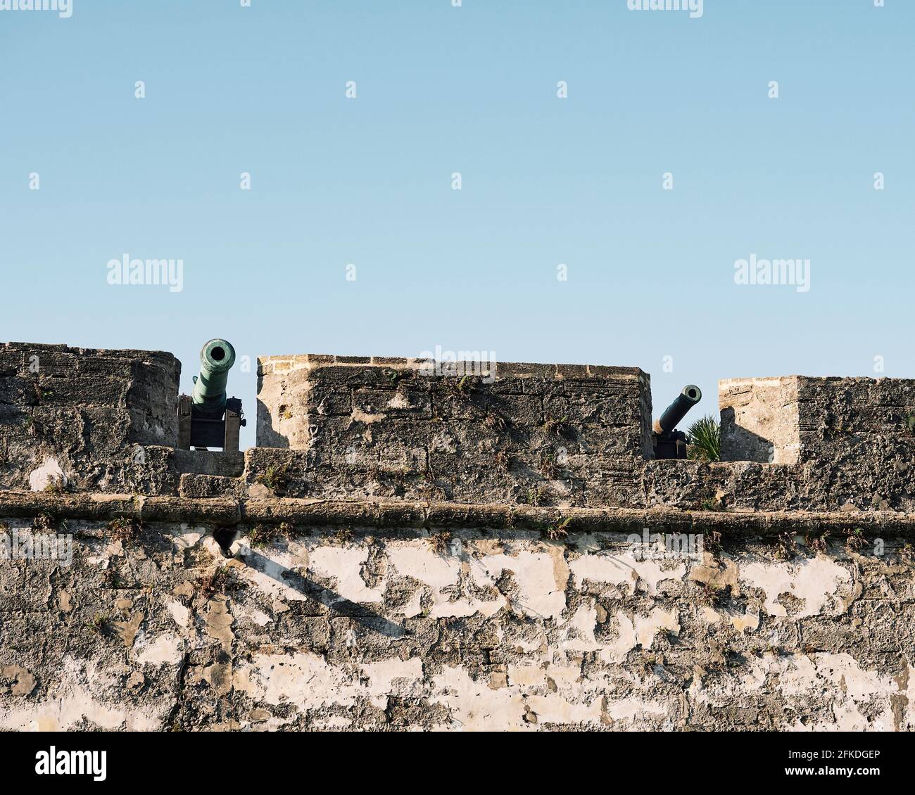 Canons on display along a stone wall of Castillo de San Marcos a 17th Century Spanish fort or fortress in St Augustine Florida, USA. Stock Photo