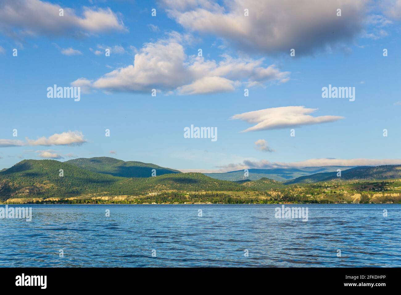 Beautiful calm summer morning on the lake with clouds on the sky Stock Photo