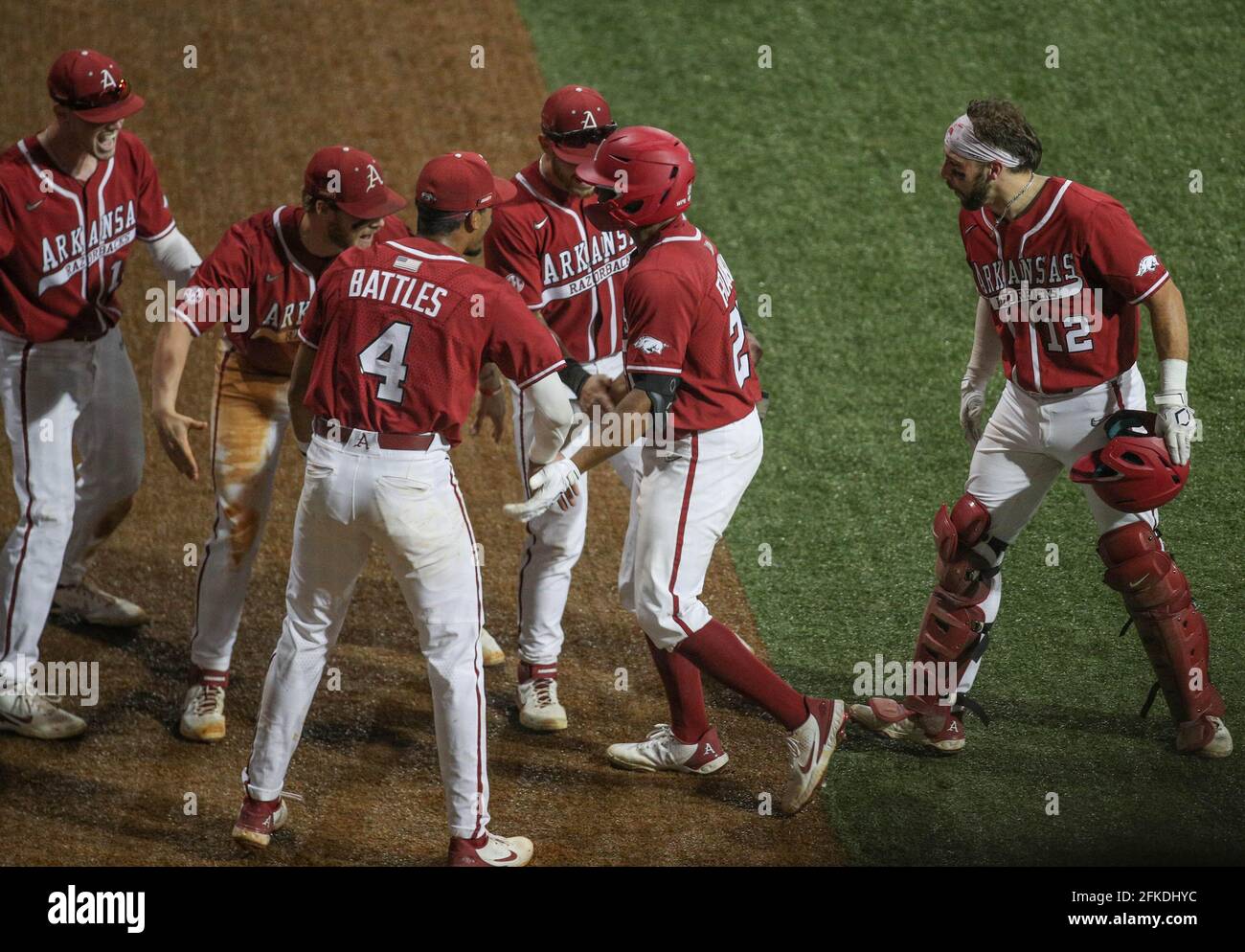 April 30, 2021: Arkansas' Christian Franklin (25) celebrates with teammate  Casey Opitz (12) and others after a grand slam during NCAA Baseball action  between the Arkansas Razorbacks and the LSU Tigers at