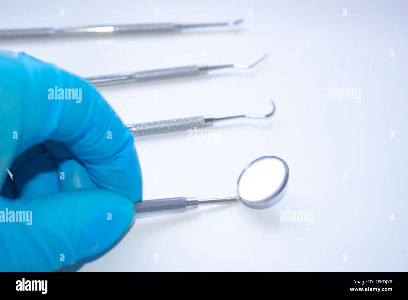 A dentist starts examining a patient. Professional Dental Hygiene
