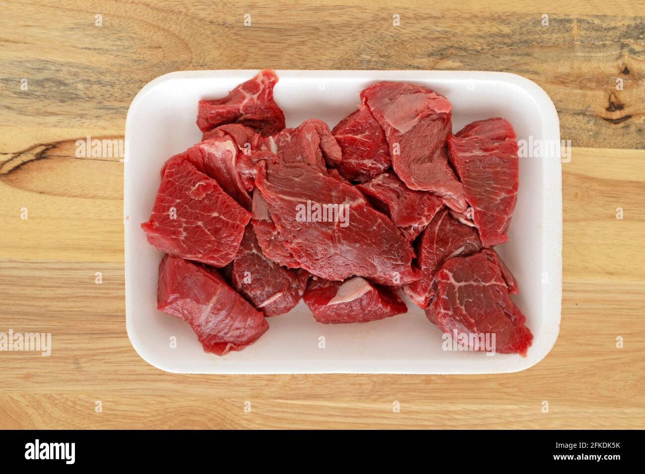 Package of Stewing Beef, Raw Meat Pieces, Chopped Stock Photo