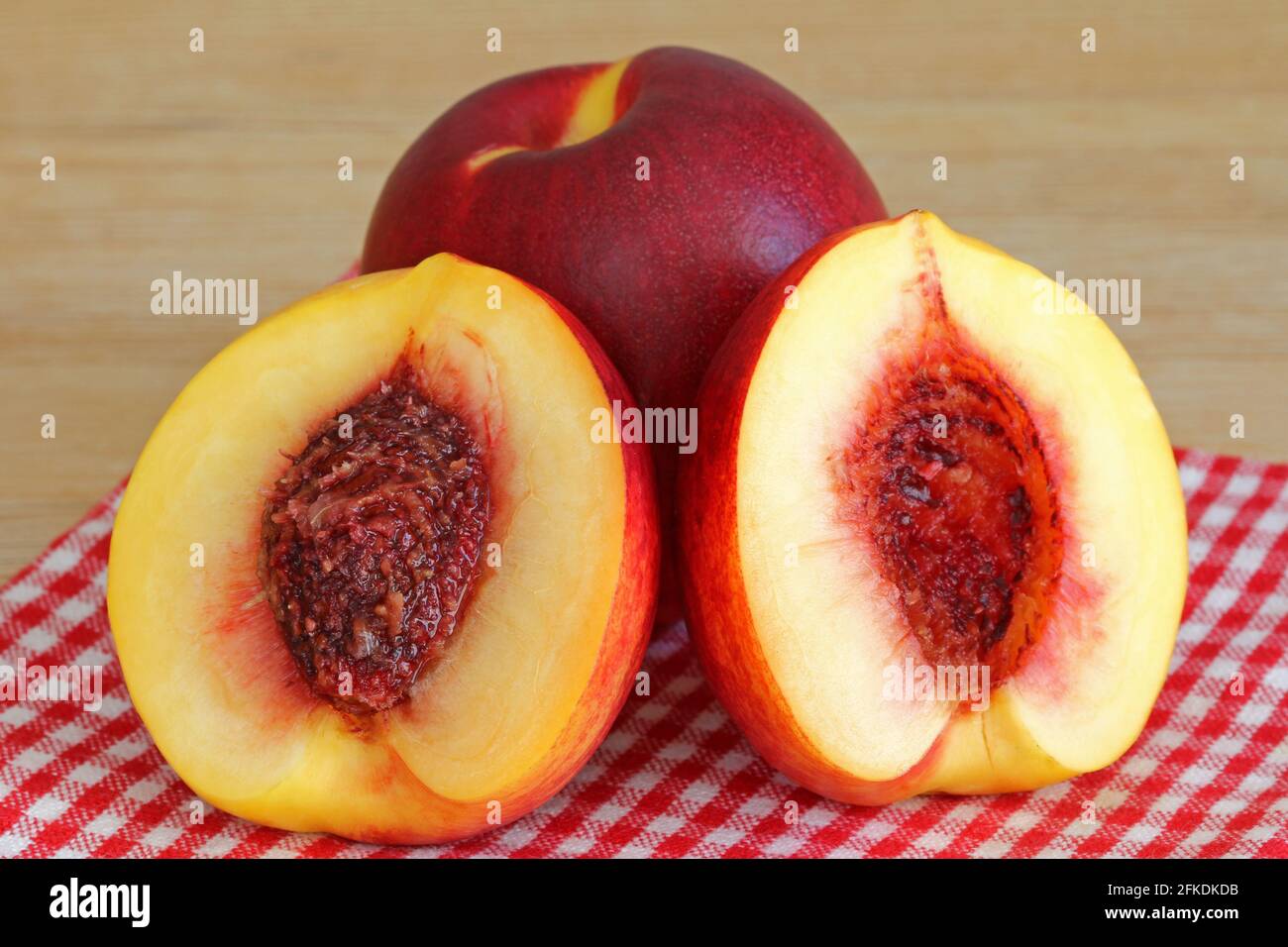 Fresh Nectarine cut in half showing a seed Stock Photo