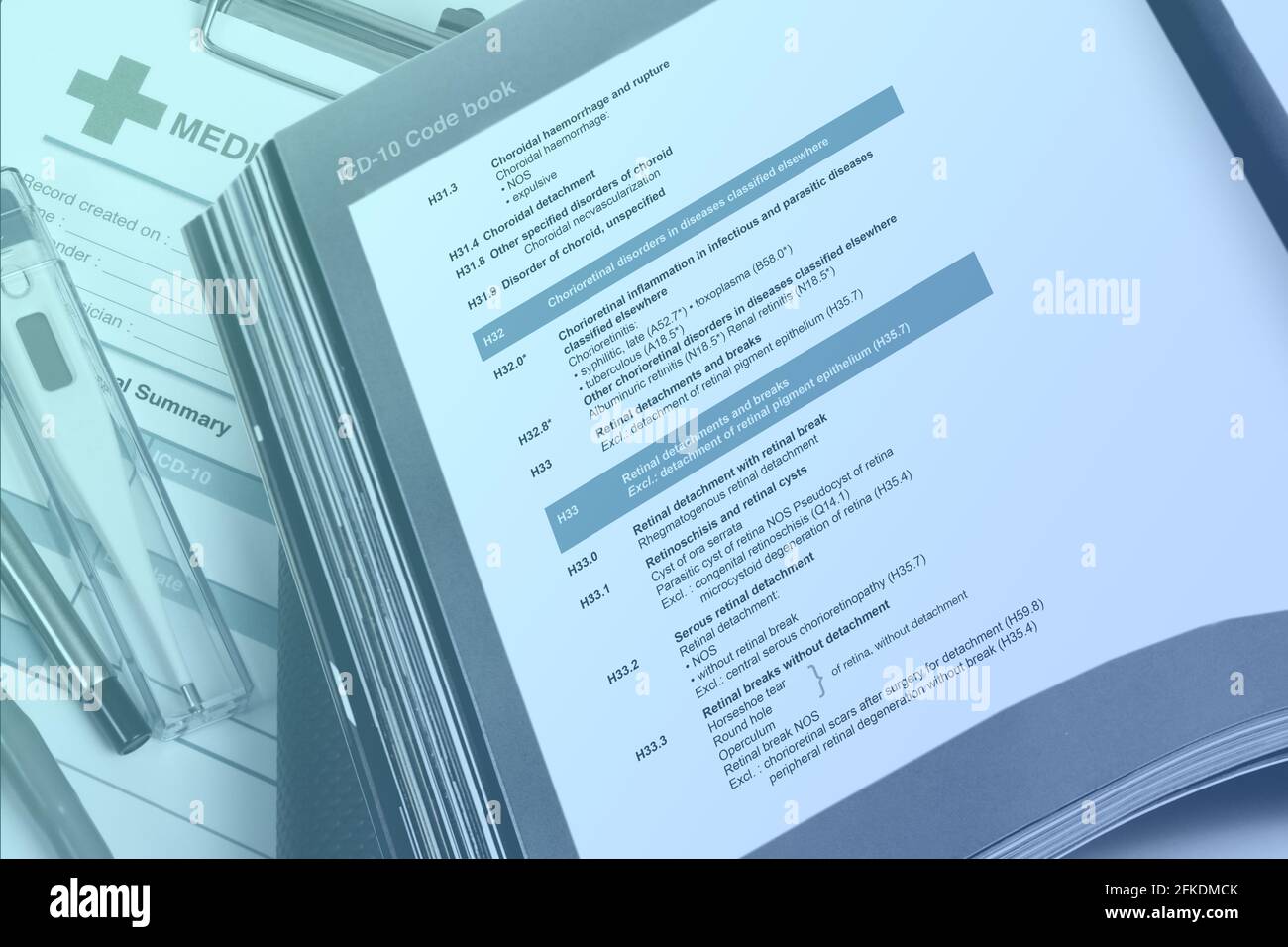 Medical code handbook opens on doctor's desk use for classification of