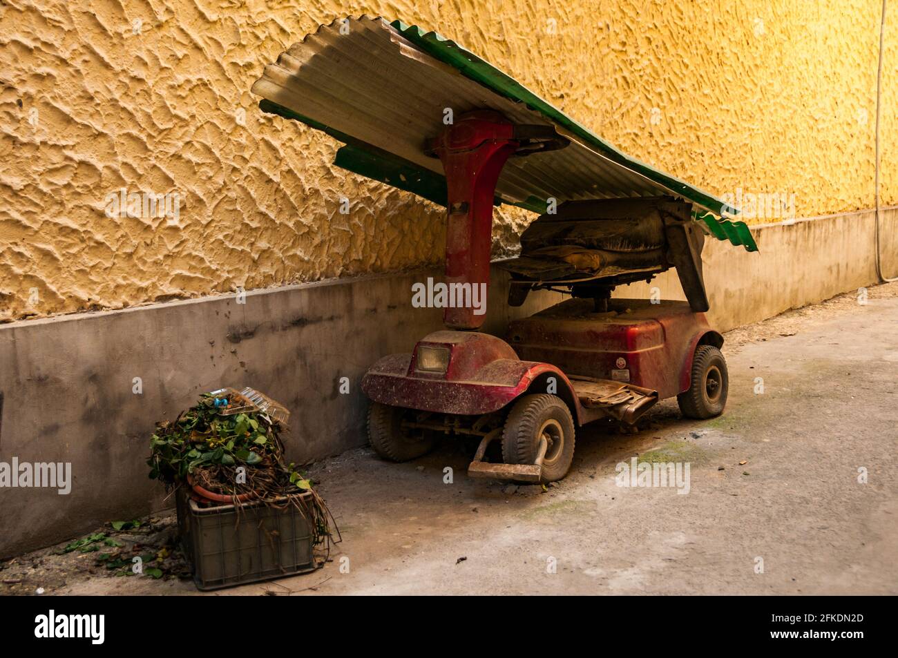 An abandoned mobility vehicle in an alleyway just off Huai Hai Zhonglu, in central Shanghai, China. Stock Photo