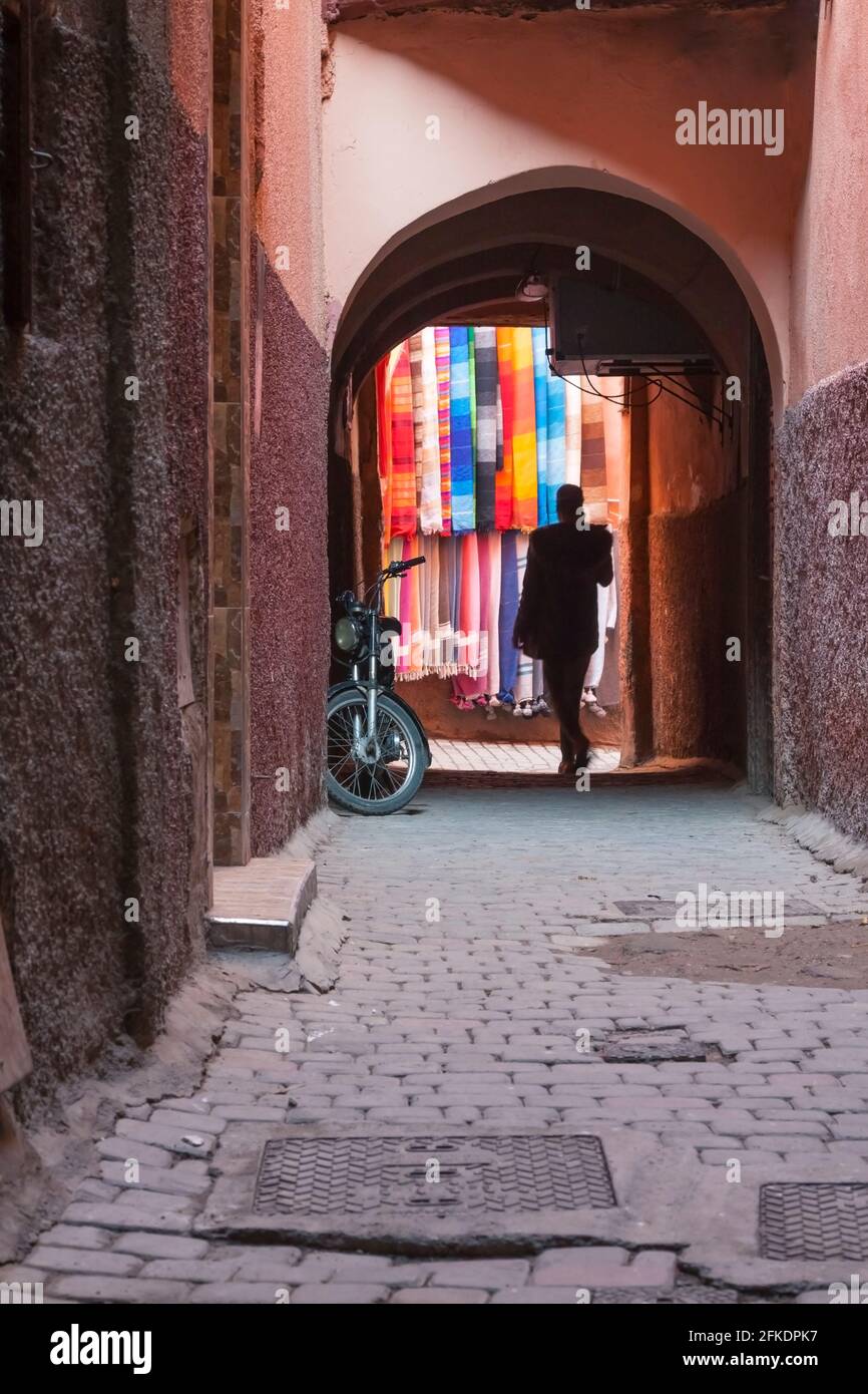 Archway and Alley in Medina Area, Marakech, Morocco, traditional scarves on the wall Stock Photo