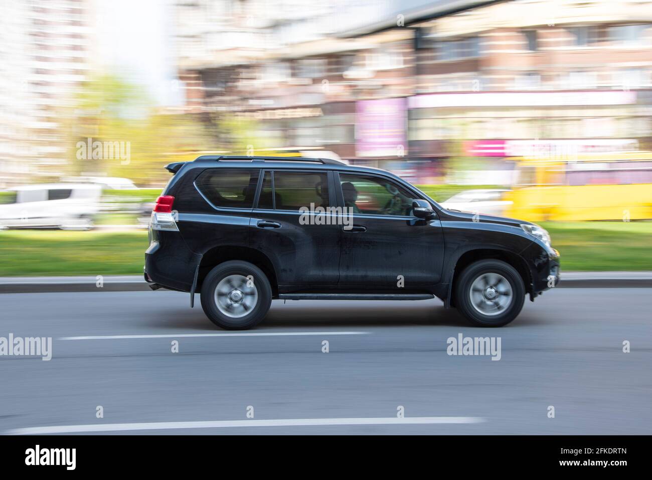 Ukraine, Kyiv - 20 April 2021: Gray Toyota Land Cruiser Prado car moving on the street. Editorial Stock Photo