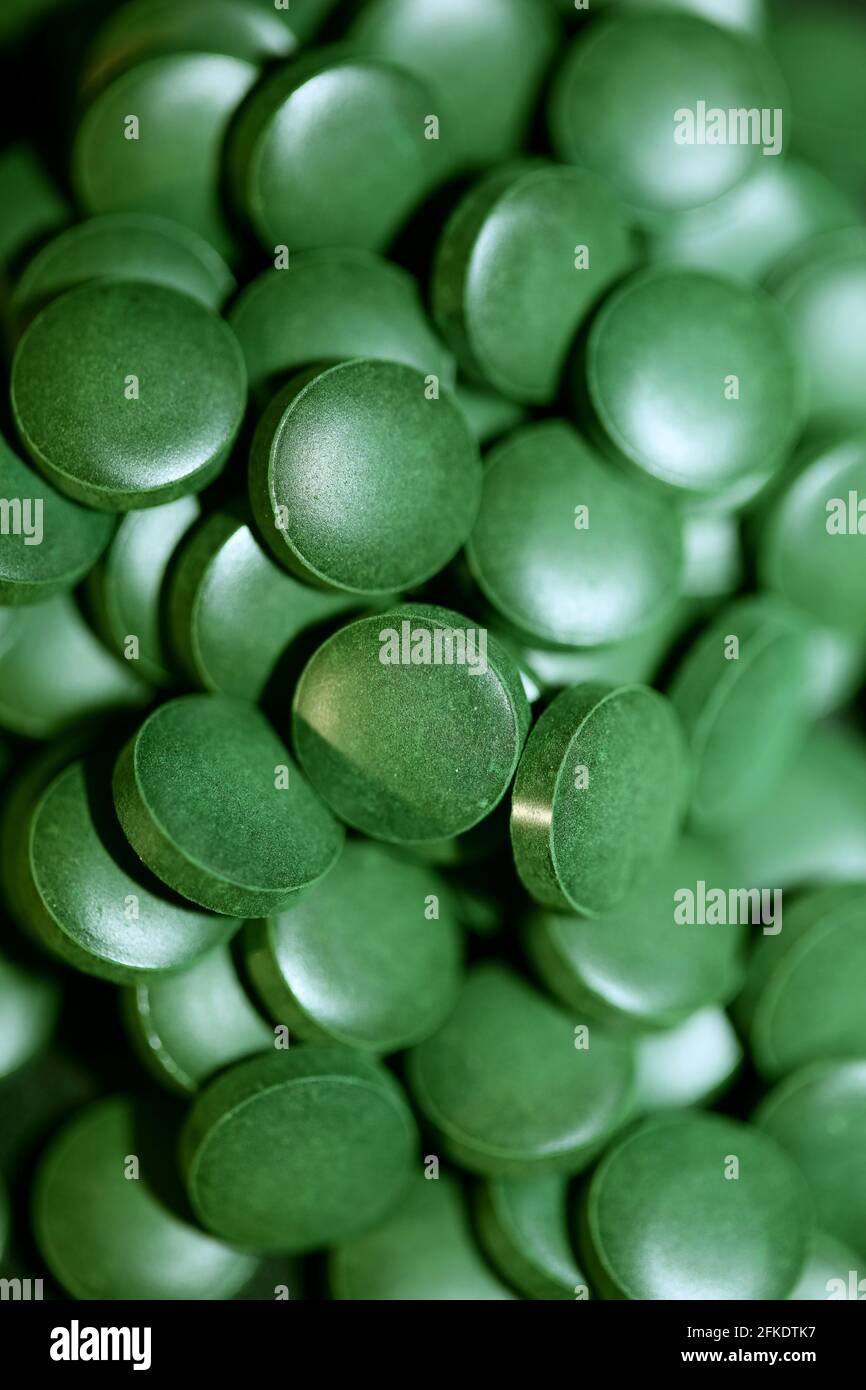 Green pills macro medical bio spirulina platensis algae family algaespace  modern trendy space food high quality big size prints Stock Photo - Alamy