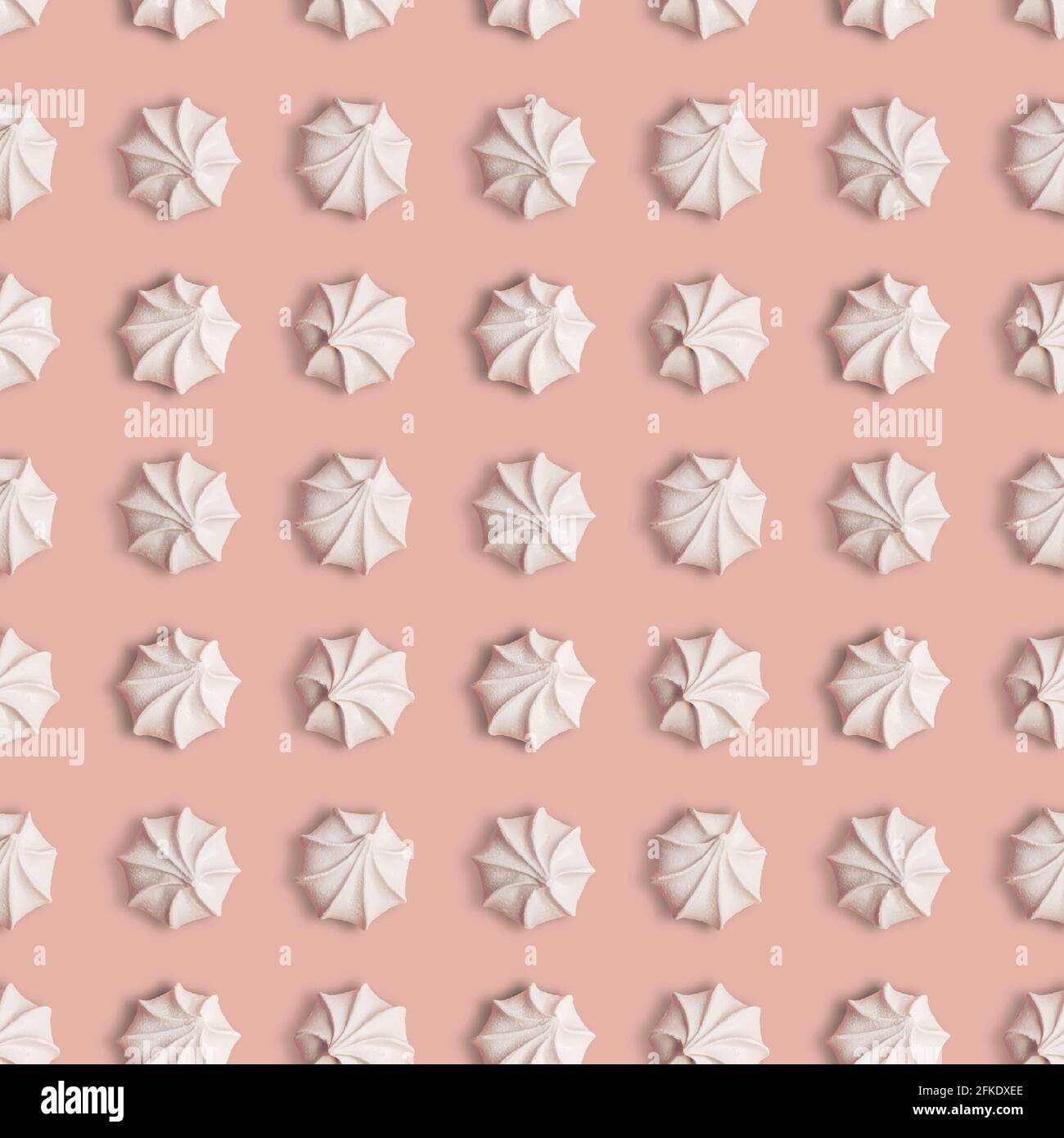 Creative seamless pattern with meringue cookies on a ligth pink background Stock Photo