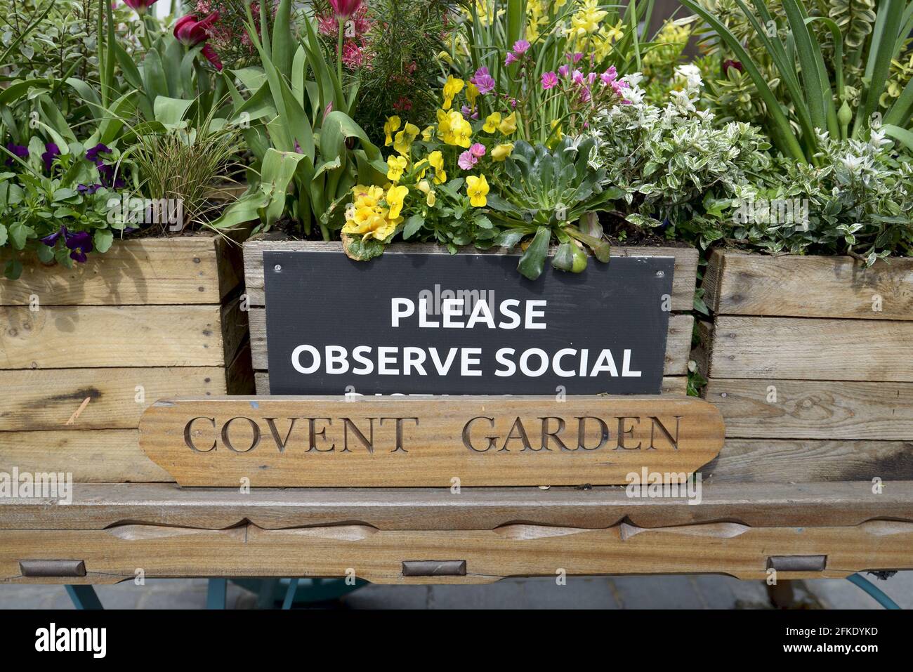 London, England, UK. Covent Garden 'Please Observe Social (Distancing)' sign welcoming shoppers back after the COVID lockdown, April 2021 Stock Photo