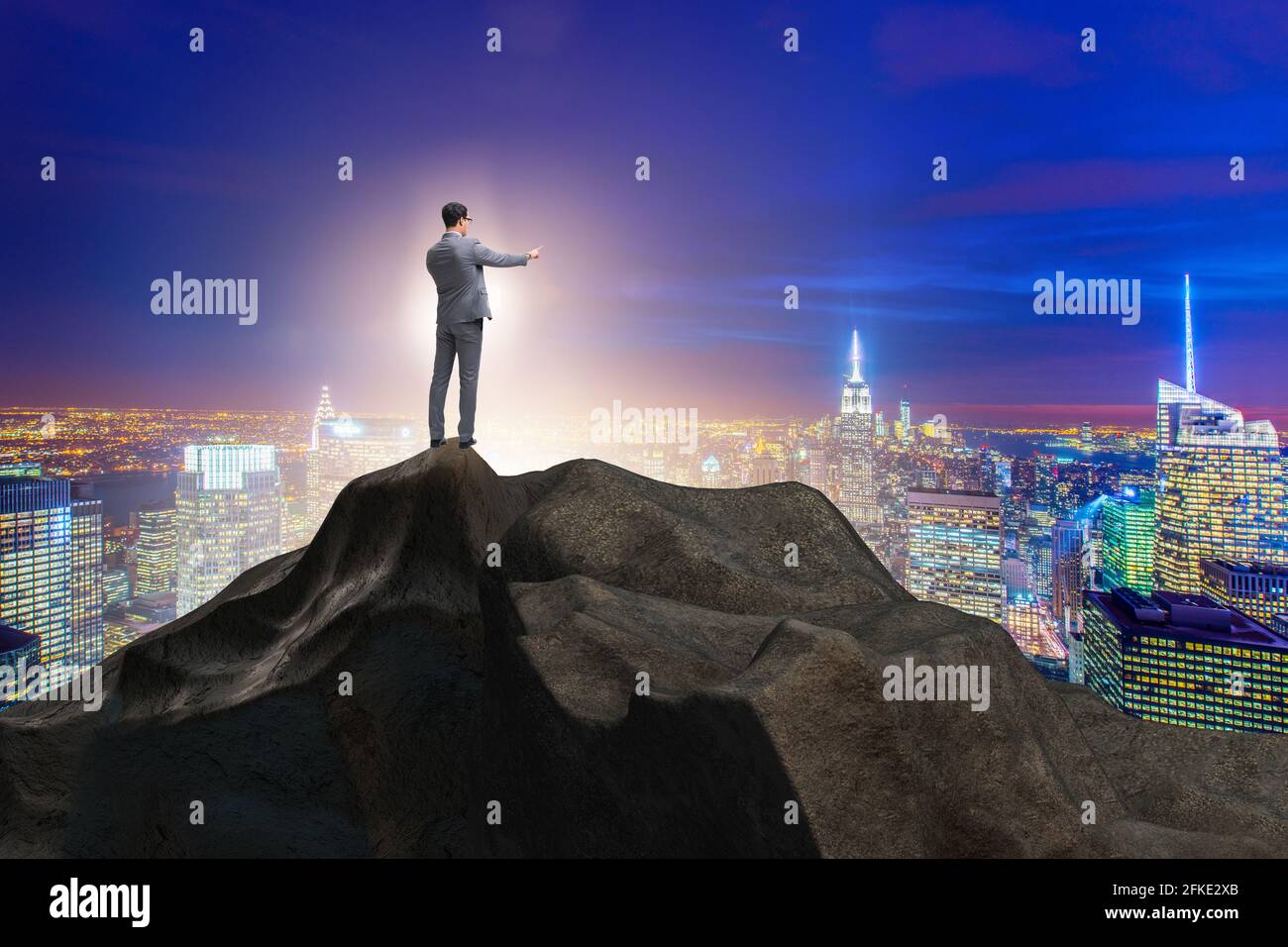 Businessman at the top of mountain in the career concept Stock Photo ...