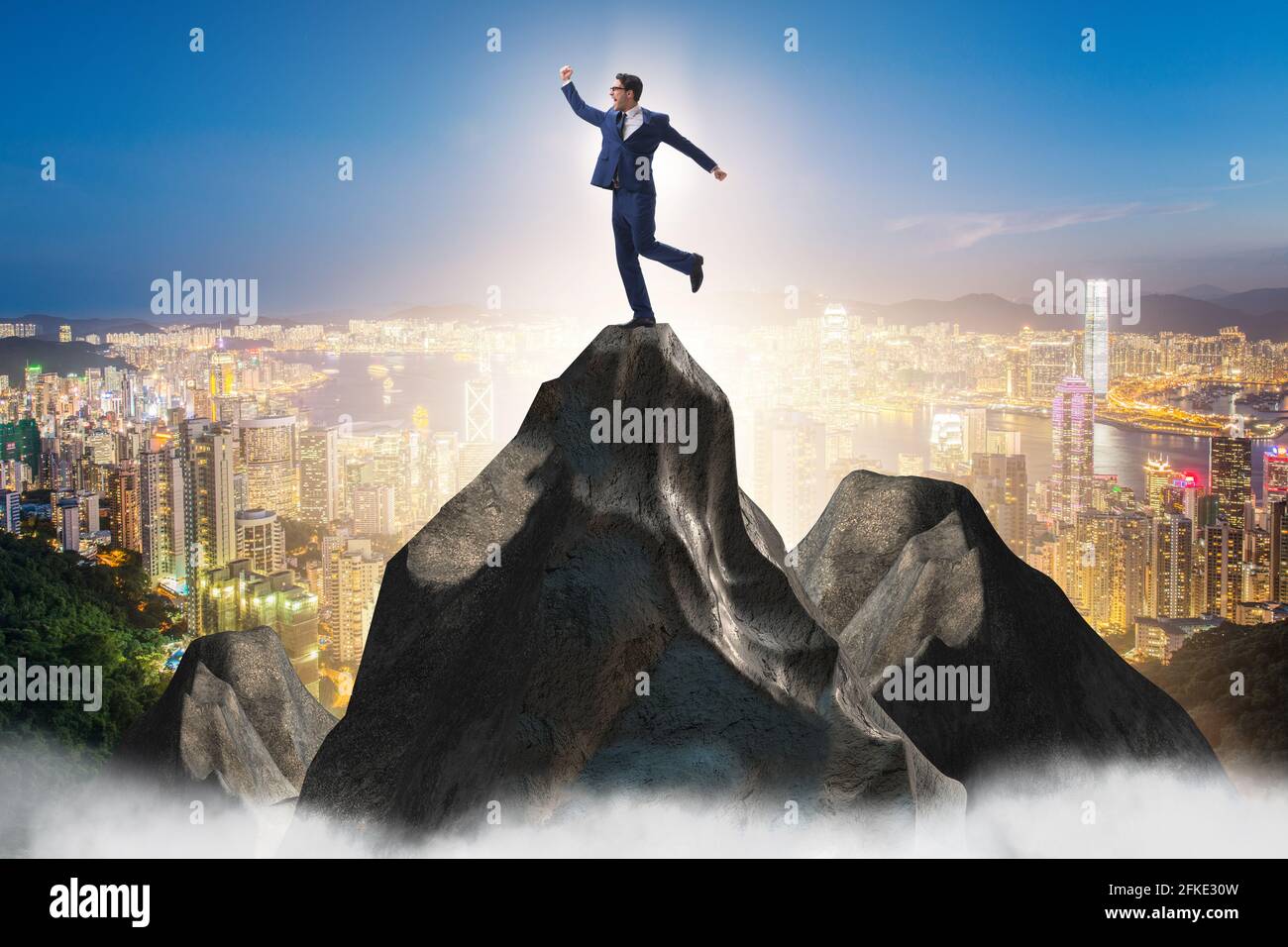 Businessman at the top of mountain in the career concept Stock Photo ...