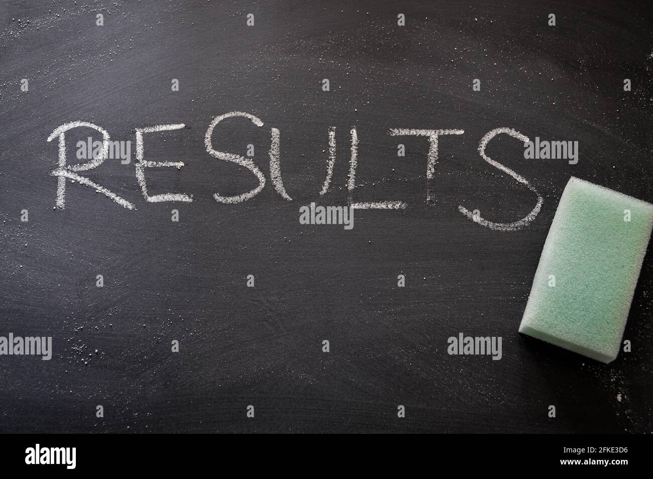 erasing results, hand written word on blackboard being erased concept Stock Photo