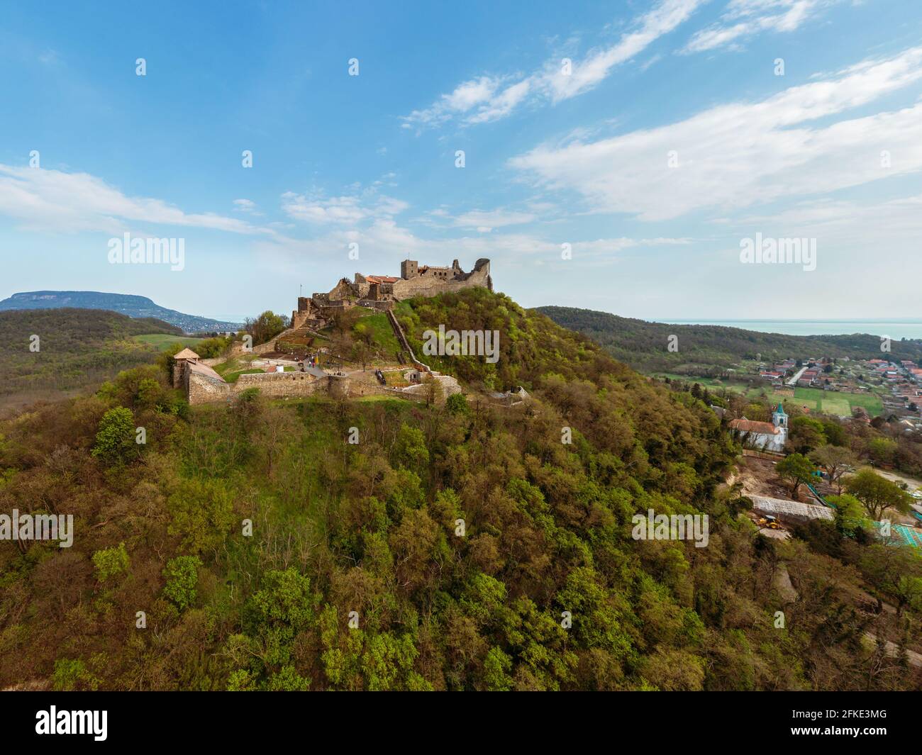 The Castle of Szigliget with Badacsony mountain next to lake Balaton in Hungary. Hisorical monument fortress ruins. Built was in 11 century, destroyed Stock Photo