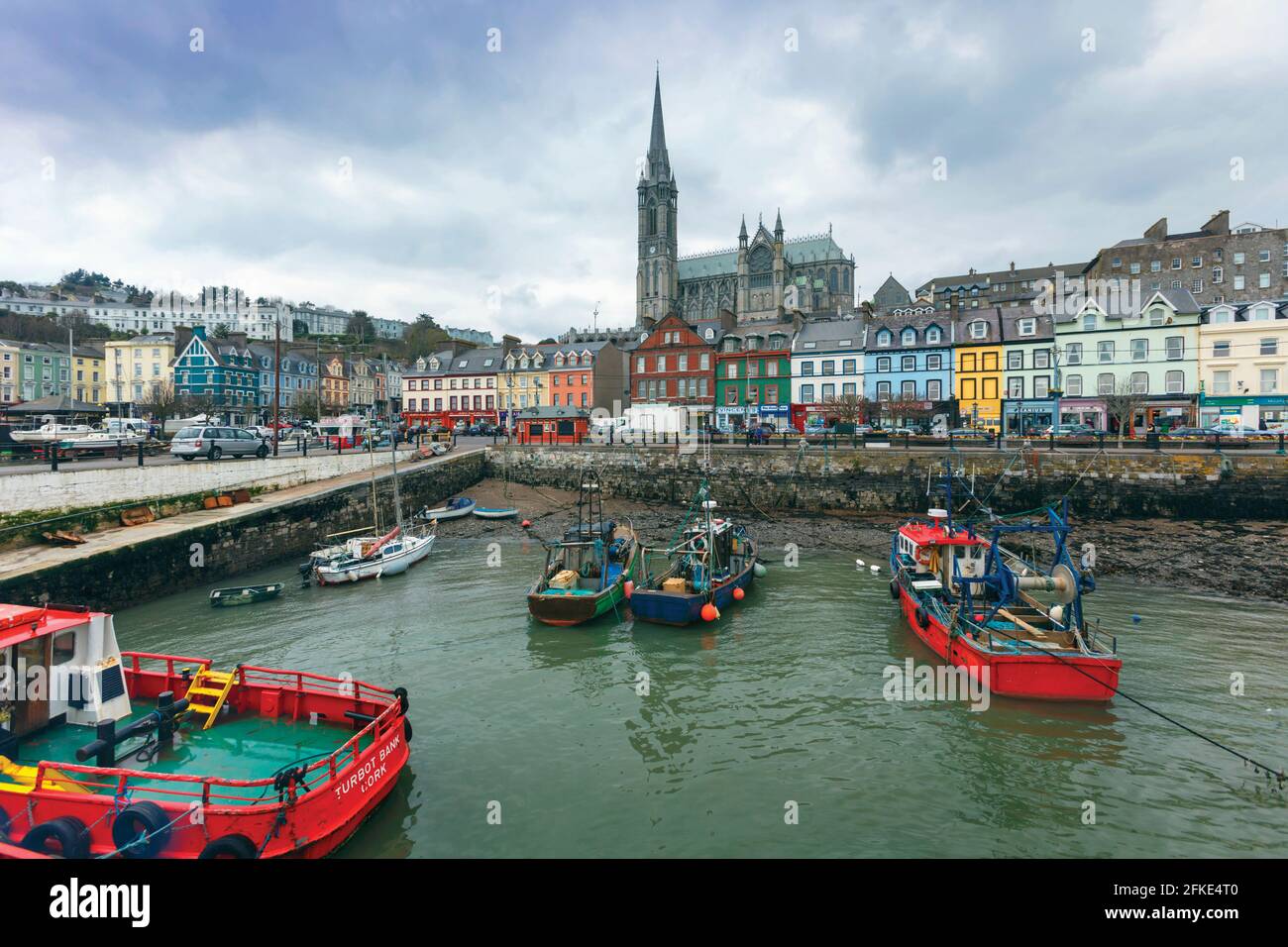 Cobh, or Cove, County Cork, Republic of Ireland. Eire.  View over harbour to St. Colman's Cathedral. Stock Photo