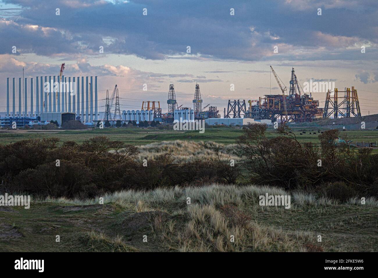Seaton Carew Golf Club with the Top Deck of Shell Brent offshore platform being dismantled and recycled at Able UK in distance . Stock Photo
