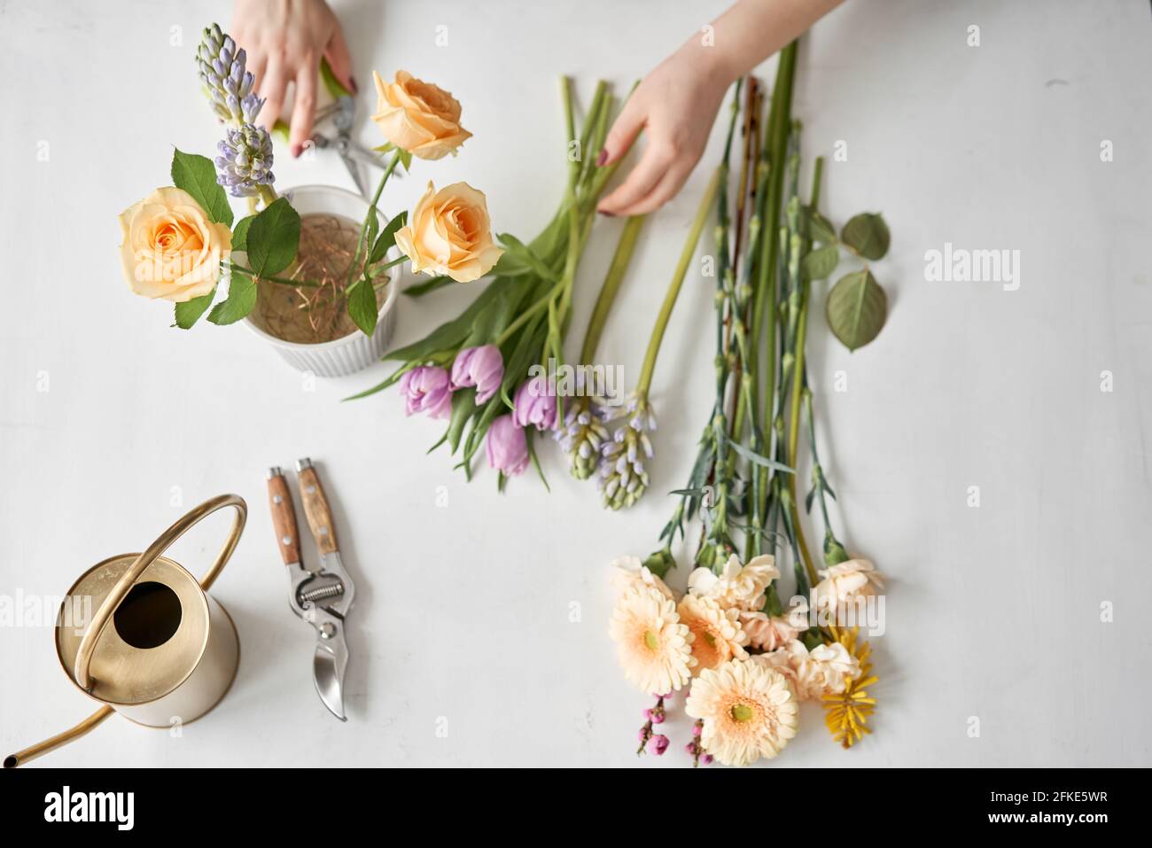 top view. Step by step installation of flowers in a vase. Flowers bunch, set for home. Fresh cut flowers for decoration home. European floral shop Stock Photo