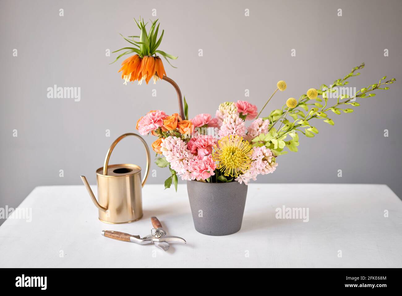 Finished flower arrangement in a vase for home. Flowers bunch, set for interior. Fresh cut flowers for decoration home. European floral shop. Delivery Stock Photo