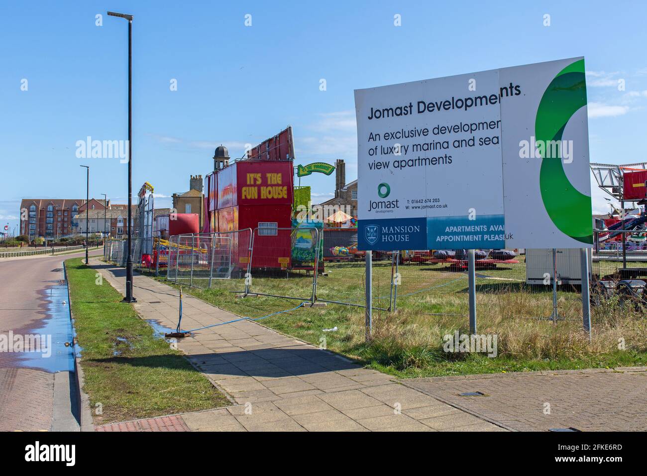 Hartlepool Marina fun fair  and sign for development  of luxury marina and sea view apartments in Hartlepool,County Durham, UK. Stock Photo