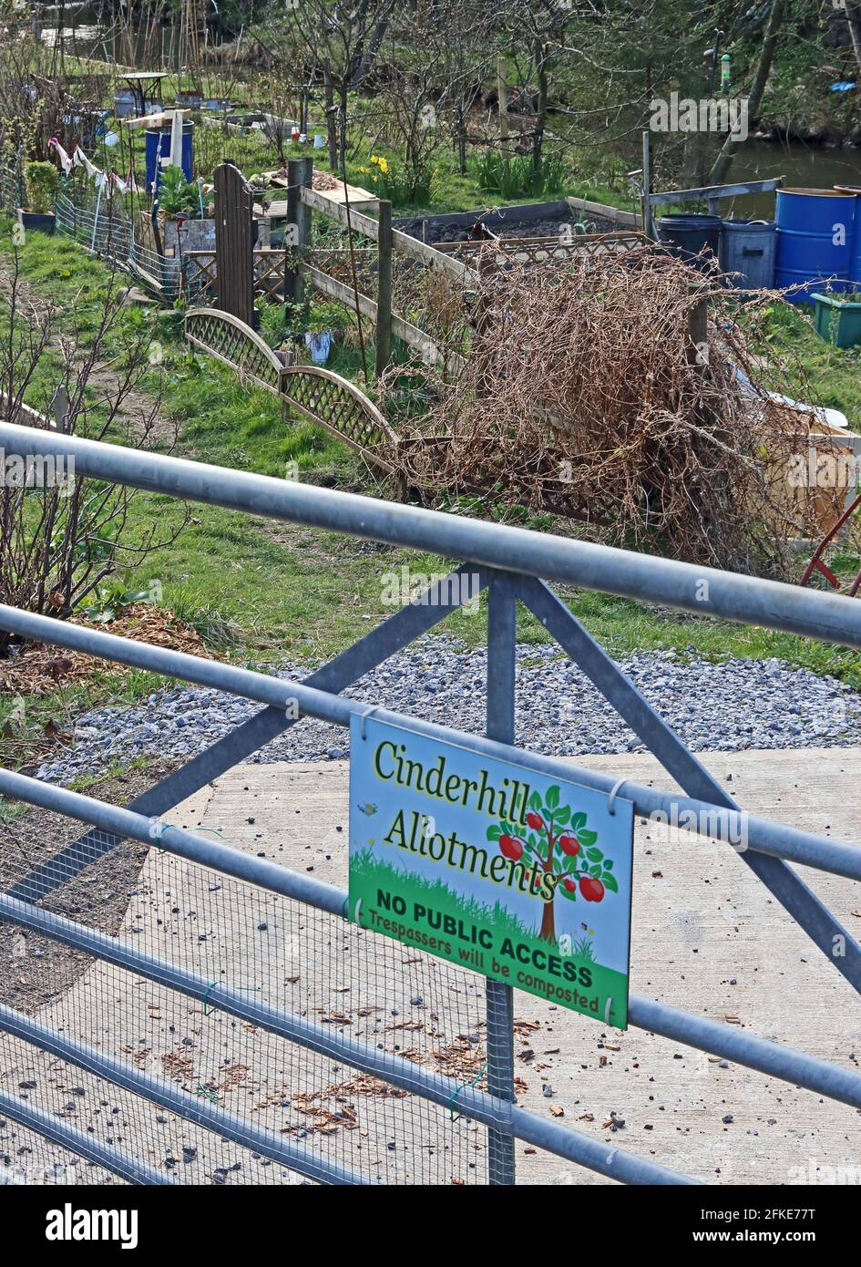 Sign on gated entrance to Cinderhill Allotments, trespassers will be composted! Stock Photo