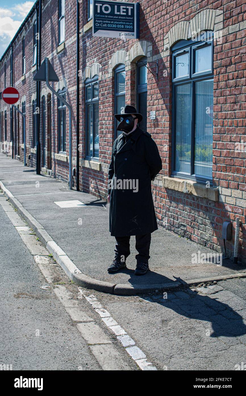 Man posing with plague mask in Hartlepool, County Durham, UK Stock Photo