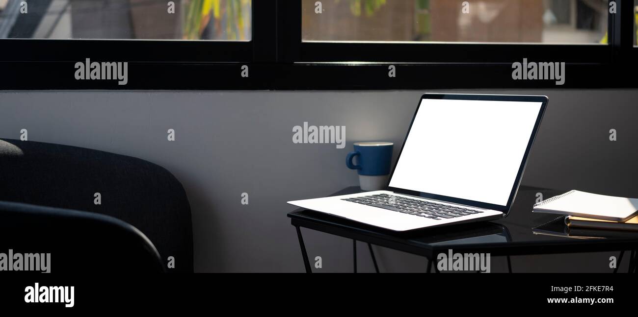 Computer laptop with empty screen on glass table in office Stock Photo ...