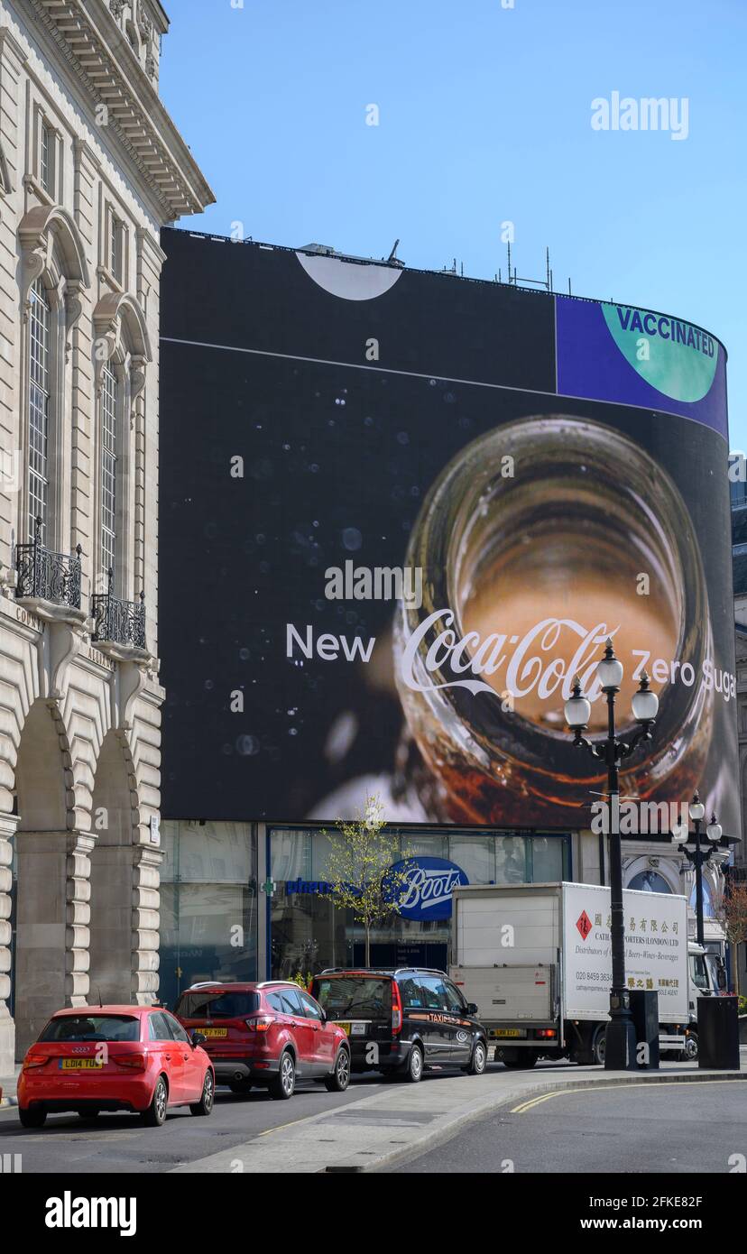 Coca Cola advertisement on Piccadilly Circus digital advertising display with queueing traffic on Regent Street, London, 30 April 2021. Stock Photo