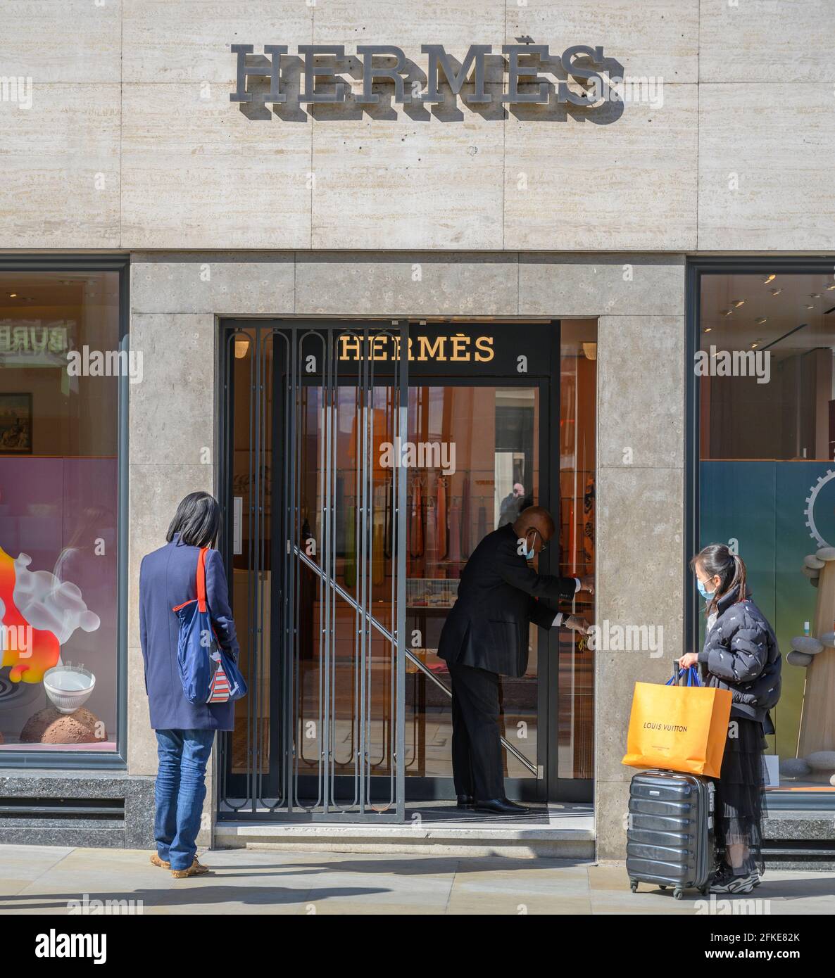shoppers queue outside Hermes luxury store in New Bond Street as the doors open for business during Covid lockdown easing, London, 30 April 2021 Stock Photo