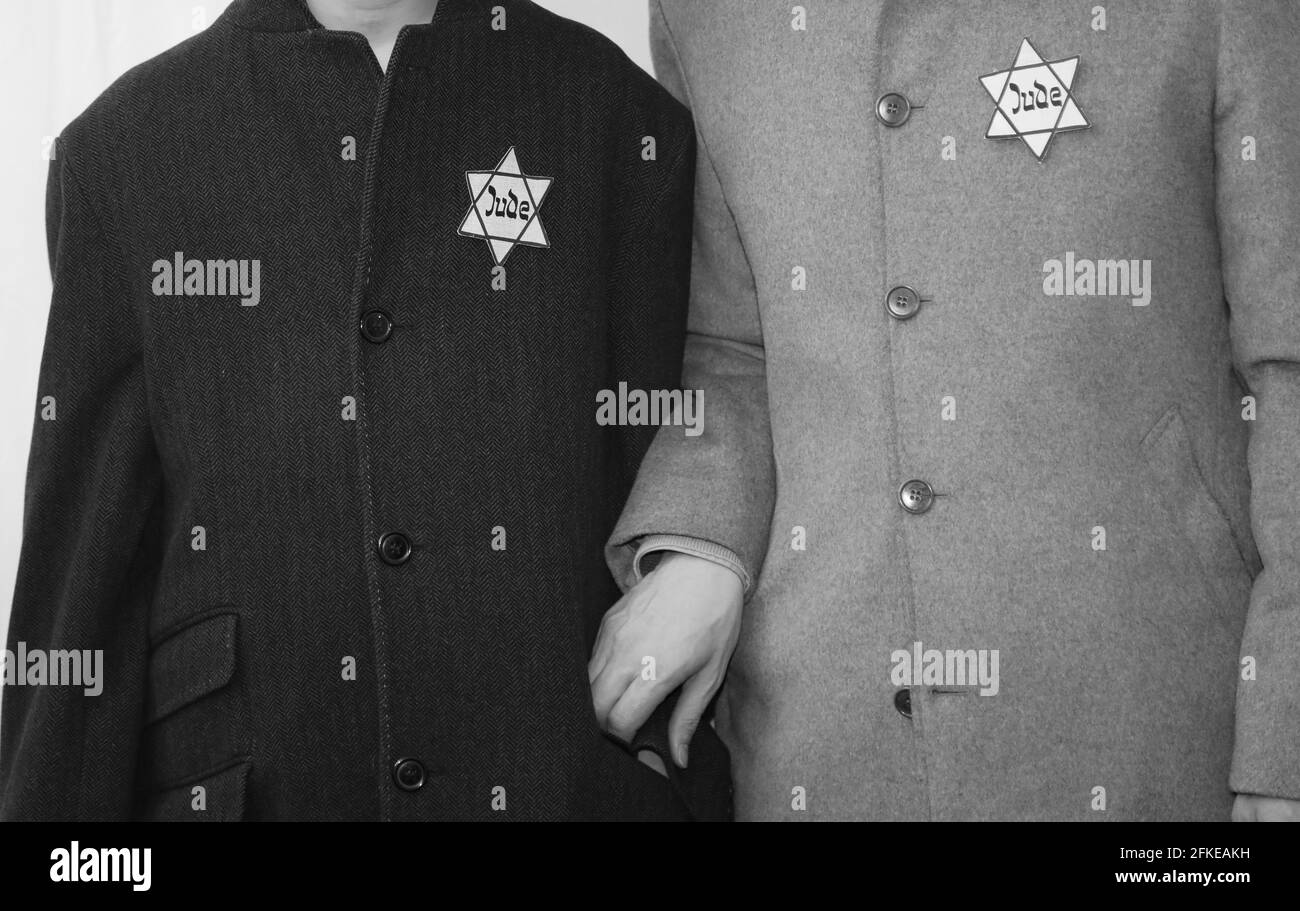 Rome, RM, Italy - March 10, 2019: historical reenactment with father and son in old 40s clothes and the star of David sewn on the clothes Stock Photo