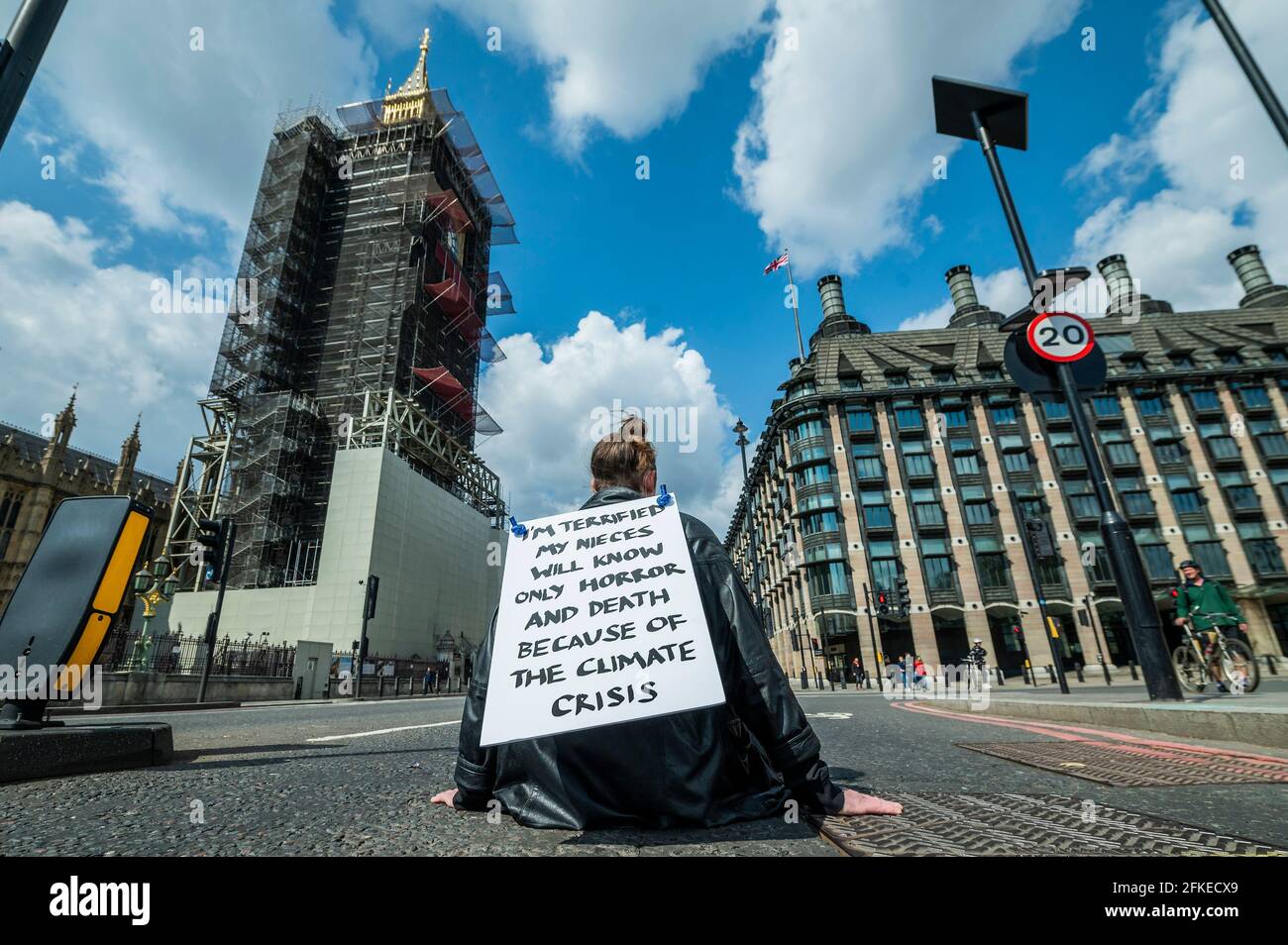 London, UK. 1st May, 2021. A man blocks one side of Westminster Bridge - Extinction Rebellion protest - At 11am on May Day (Saturday 1st May) hundreds of people across the UK take action, individually, in different disruptive locations to mark the second anniversary of Parliament's declaration of environmental and climate emergency in 2019. Credit: Guy Bell/Alamy Live News Stock Photo